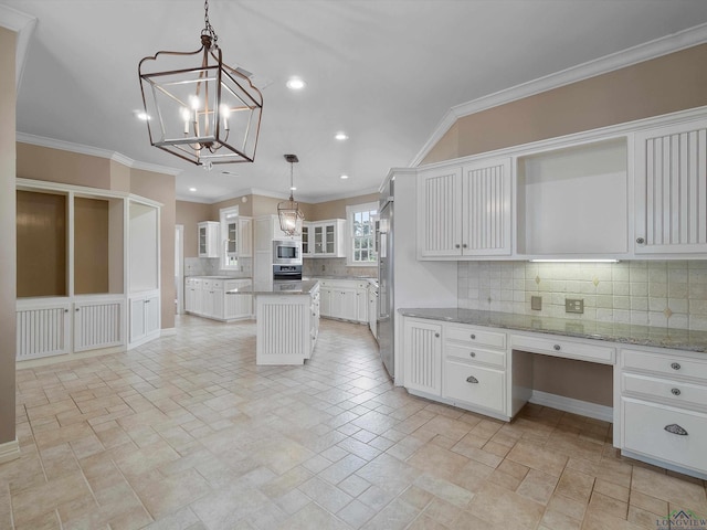 kitchen with pendant lighting, a center island, white cabinetry, and crown molding