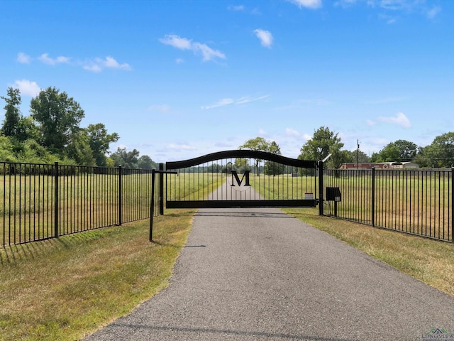 view of gate featuring a lawn