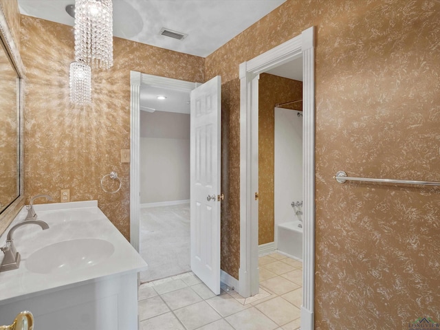 bathroom with tile patterned flooring, vanity, and  shower combination