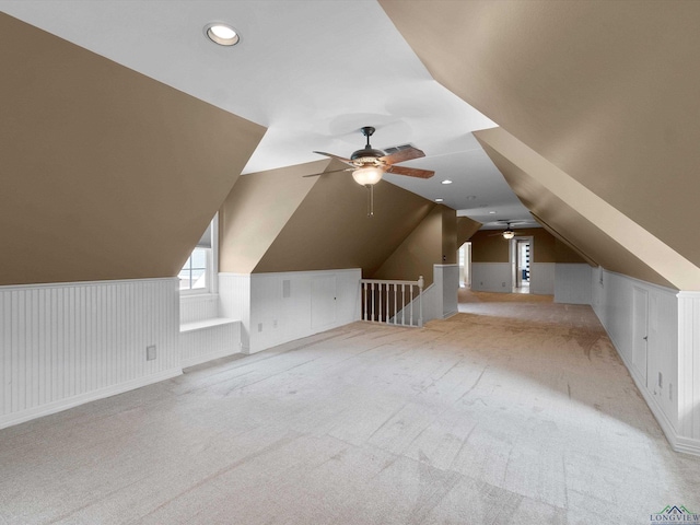 bonus room featuring light colored carpet, vaulted ceiling, and ceiling fan