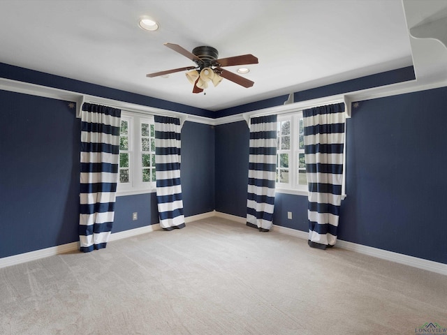 carpeted empty room featuring ceiling fan