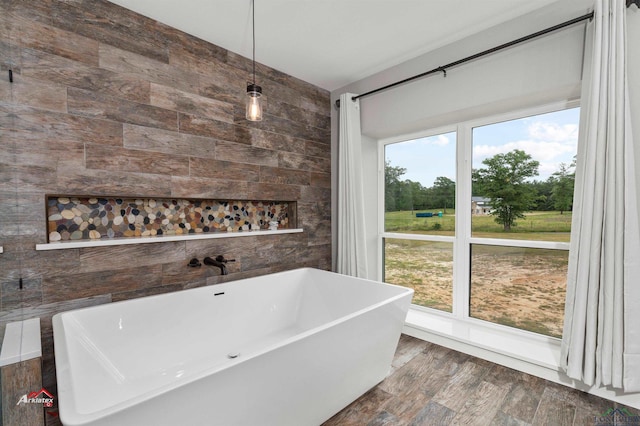 bathroom featuring wood-type flooring and a tub