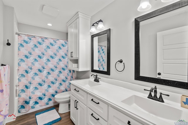 full bathroom featuring shower / bathtub combination with curtain, vanity, wood-type flooring, and toilet