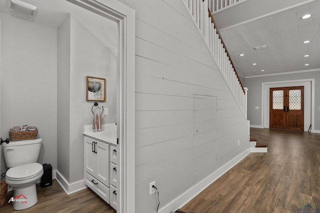 foyer with french doors, dark hardwood / wood-style flooring, and crown molding