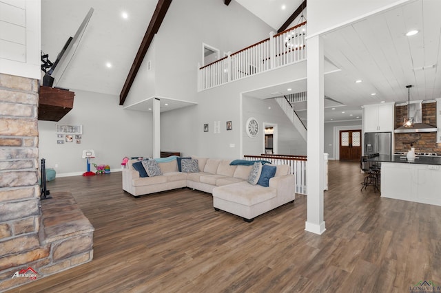 living room with beamed ceiling, dark hardwood / wood-style floors, and high vaulted ceiling