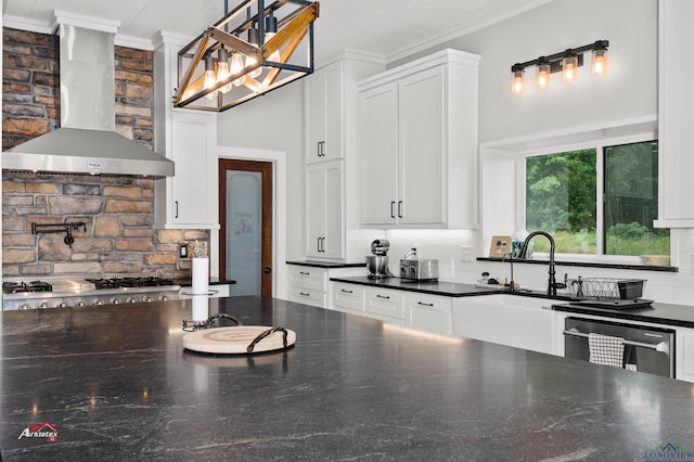 kitchen featuring decorative backsplash, white cabinetry, and wall chimney exhaust hood