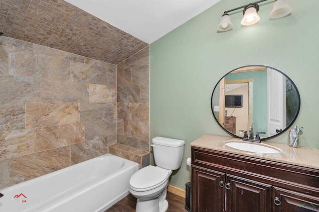 bathroom featuring vanity, vaulted ceiling, and toilet