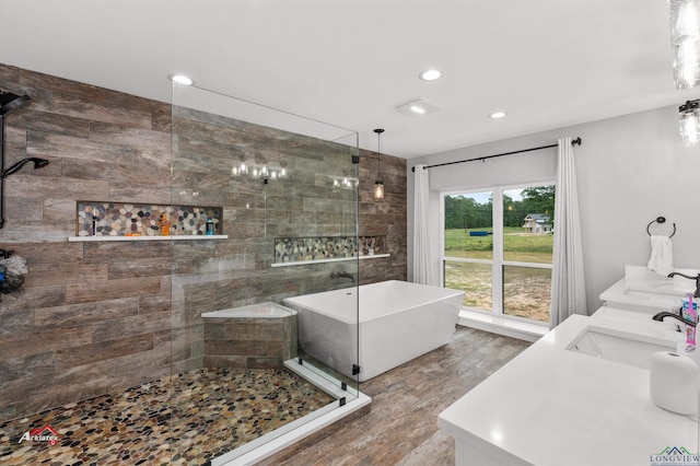 bathroom with hardwood / wood-style floors, vanity, and independent shower and bath