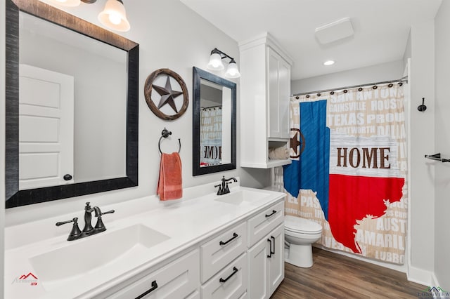 bathroom featuring hardwood / wood-style floors, vanity, and toilet