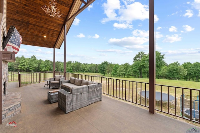 view of patio with an outdoor living space and a trampoline