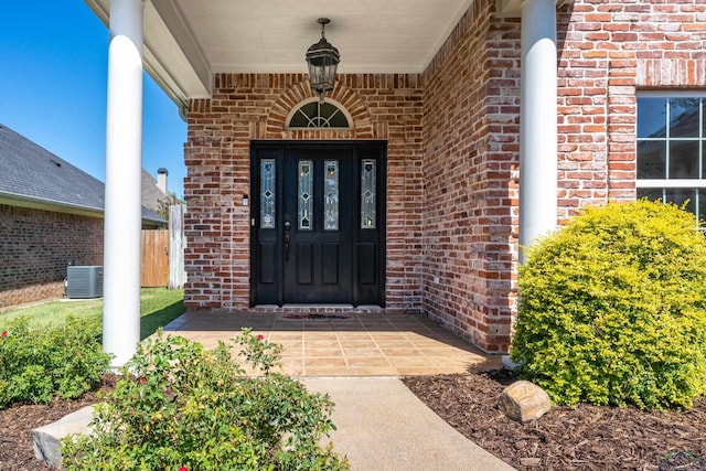 doorway to property featuring central air condition unit