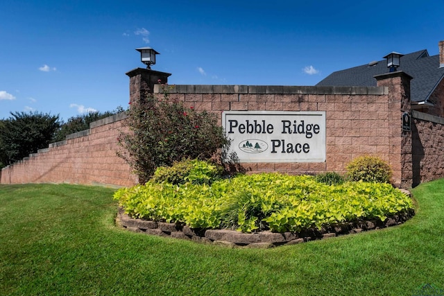 community / neighborhood sign with a lawn