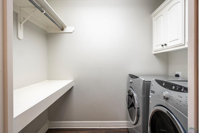 washroom with washer and clothes dryer and cabinets