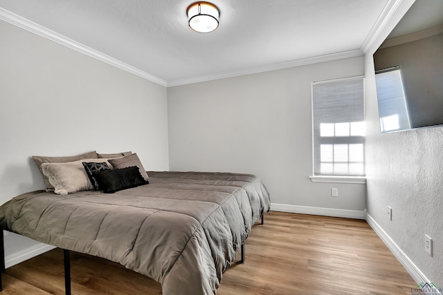 bedroom featuring light hardwood / wood-style flooring and ornamental molding