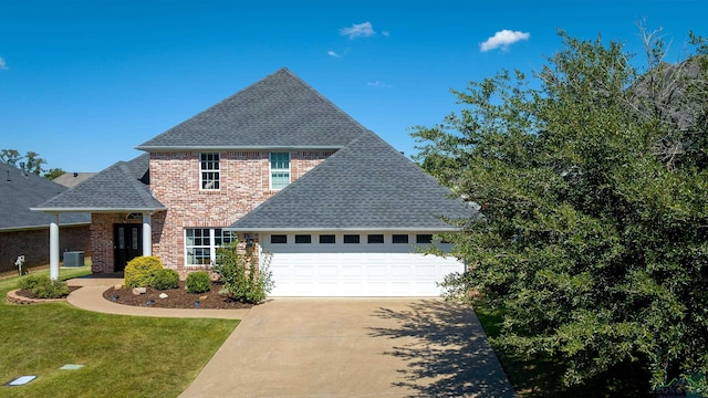 view of front of property featuring a garage, central air condition unit, and a front lawn