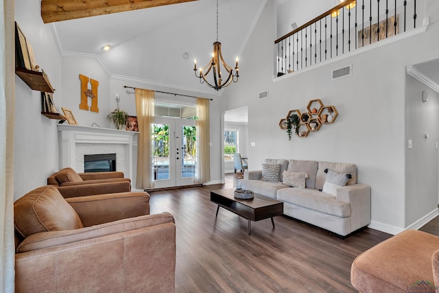 living room with french doors, a brick fireplace, high vaulted ceiling, an inviting chandelier, and dark hardwood / wood-style floors