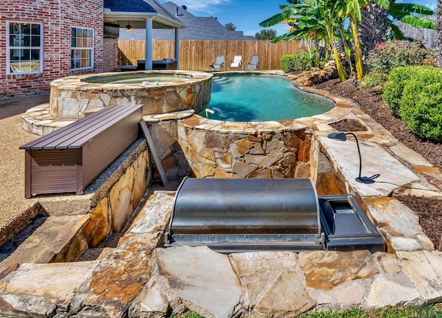 view of pool featuring an in ground hot tub