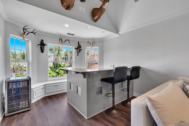 bar featuring ornamental molding, beverage cooler, dark hardwood / wood-style floors, white cabinetry, and lofted ceiling