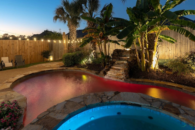 view of pool at dusk