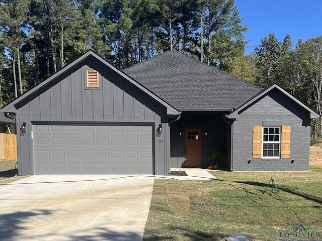 single story home with a garage and a front lawn