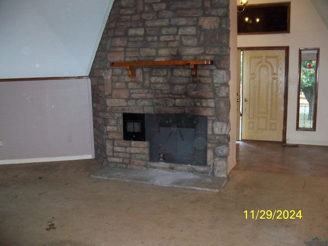 unfurnished living room featuring carpet, a stone fireplace, and lofted ceiling