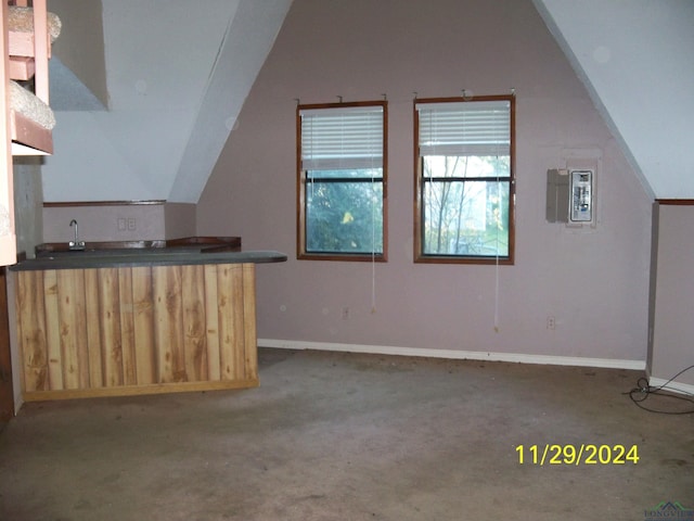 additional living space featuring electric panel and lofted ceiling