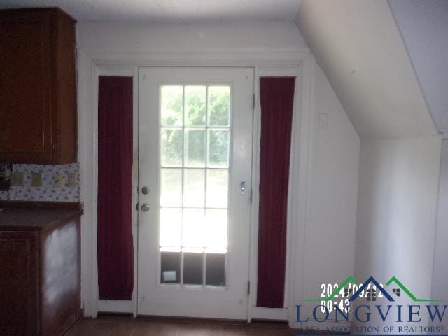 doorway featuring lofted ceiling