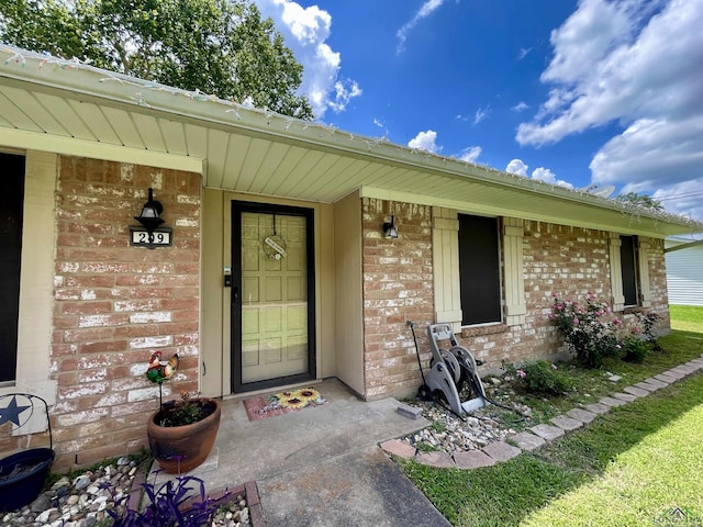 209 Lake Lamond Rd, Longview, TX 75604 - view of exterior entry with brick siding and a porch