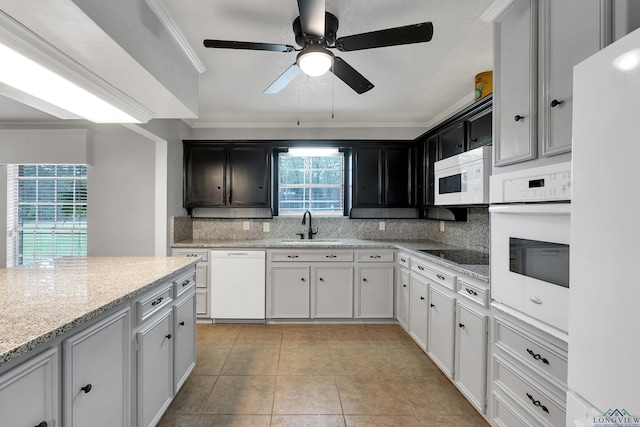 kitchen featuring a sink, decorative backsplash, a ceiling fan, and white appliances