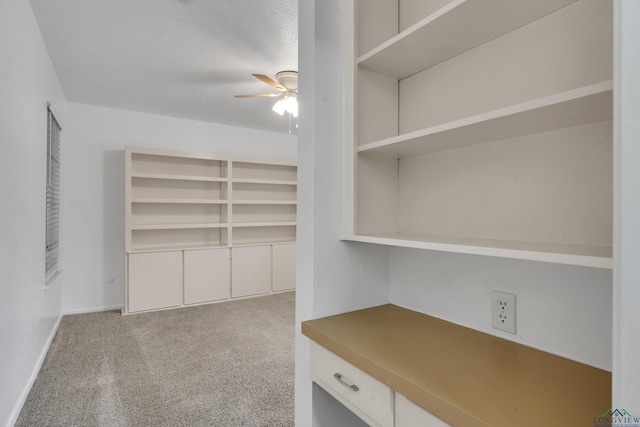 interior space featuring baseboards, a ceiling fan, and carpet flooring
