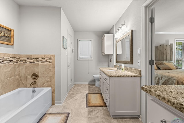 8 Honeysuckle Ln, Longview, TX 75605 - bathroom featuring vanity, ensuite bathroom, a garden tub, toilet, and baseboards