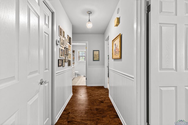 8 Honeysuckle Ln, Longview, TX 75605 - hall featuring dark wood-type flooring and a wainscoted wall