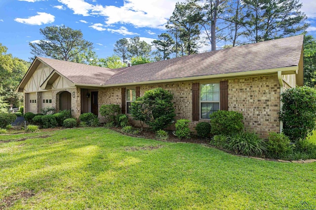 8 Honeysuckle Ln, Longview, TX 75605 - view of front of house with a garage, a shingled roof, brick siding, and a front yard
