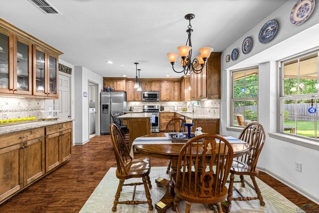 8 Honeysuckle Ln, Longview, TX 75605 - dining room featuring dark wood finished floors, a chandelier, baseboards, and recessed lighting