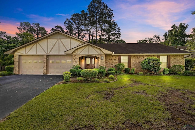 8 Honeysuckle Ln, Longview, TX 75605 - view of front of house with brick siding, driveway, an attached garage, and a front lawn