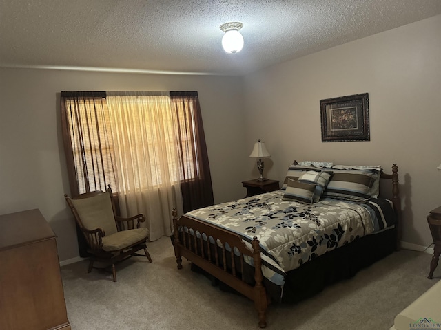 bedroom featuring carpet flooring, a textured ceiling, and baseboards