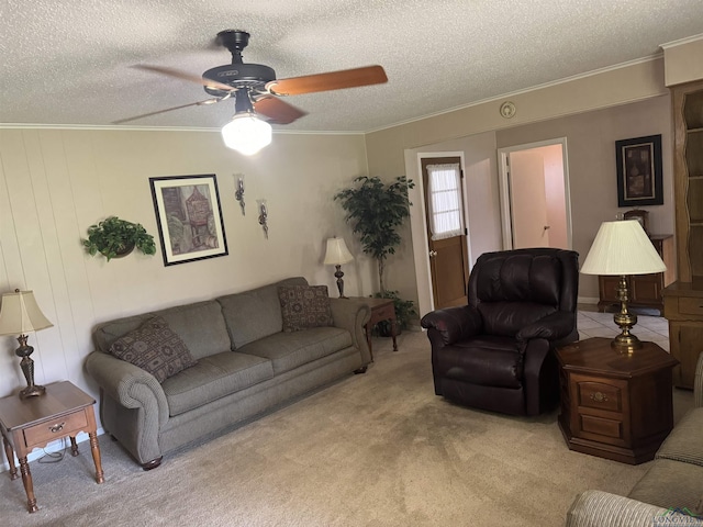 living area featuring a textured ceiling, ceiling fan, and light carpet