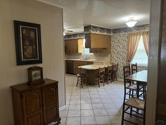dining area featuring crown molding, a ceiling fan, a textured ceiling, and wallpapered walls