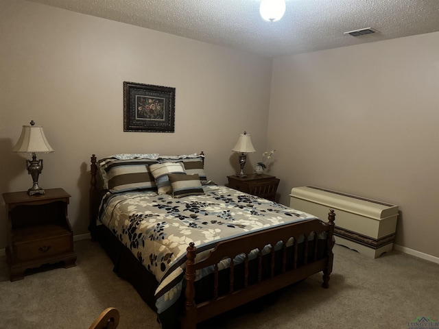 bedroom with baseboards, light colored carpet, a textured ceiling, and visible vents