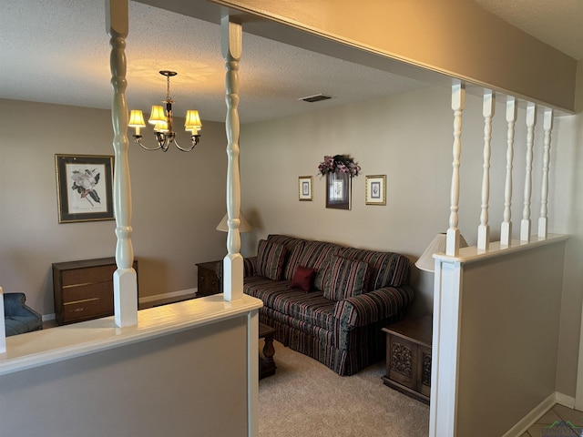 carpeted living room featuring visible vents, a textured ceiling, and an inviting chandelier