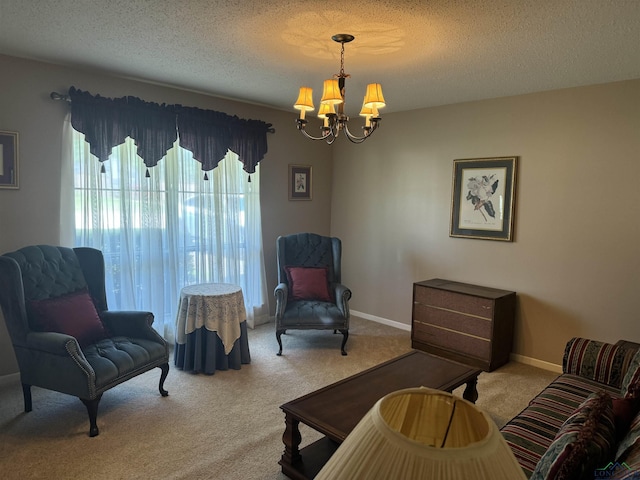 sitting room with baseboards, a textured ceiling, a chandelier, and light carpet