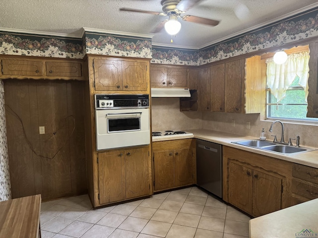 kitchen with a sink, white appliances, light countertops, a ceiling fan, and under cabinet range hood