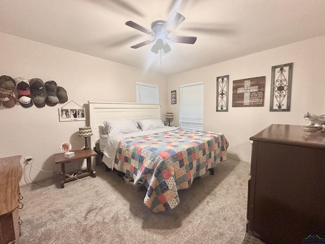 bedroom with a ceiling fan and carpet flooring