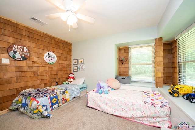 12545 Fm 968 W, Longview, TX 75602 - bedroom with wood walls, carpet floors, and a ceiling fan
