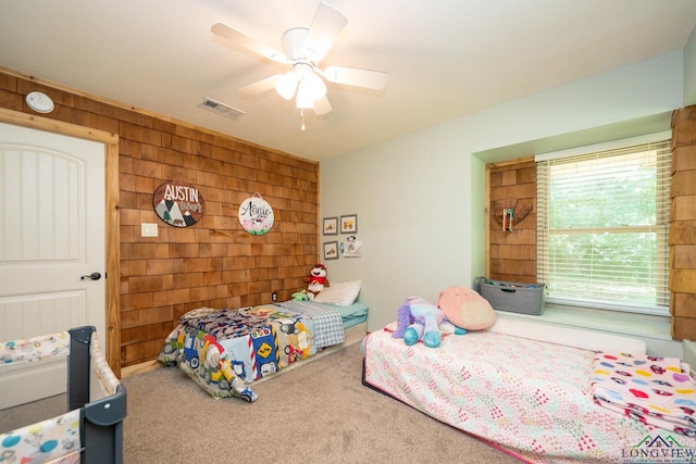 12545 Fm 968 W, Longview, TX 75602 - carpeted bedroom featuring wood walls and a ceiling fan