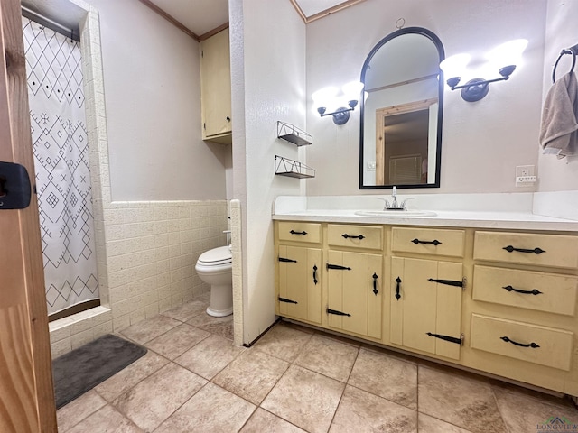 bathroom featuring vanity, curtained shower, tile walls, a wainscoted wall, and toilet