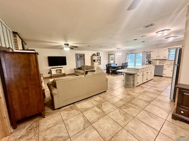 living room featuring ceiling fan, light tile patterned flooring, and visible vents