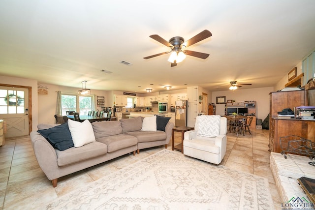 12545 Fm 968 W, Longview, TX 75602 - living area with a ceiling fan and light tile patterned floors