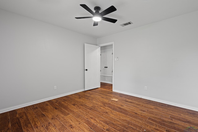 spare room featuring visible vents, wood finished floors, and a ceiling fan