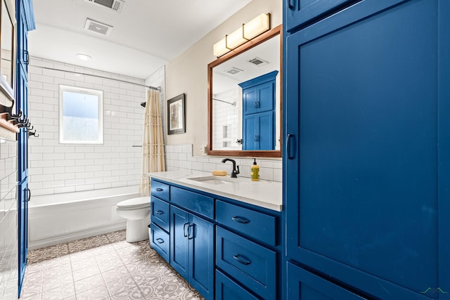 bathroom with toilet, vanity, tile patterned flooring, and visible vents